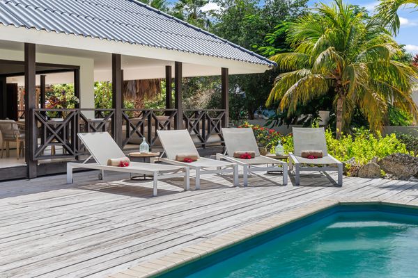 Sunbeds on the wooden deck at the pool