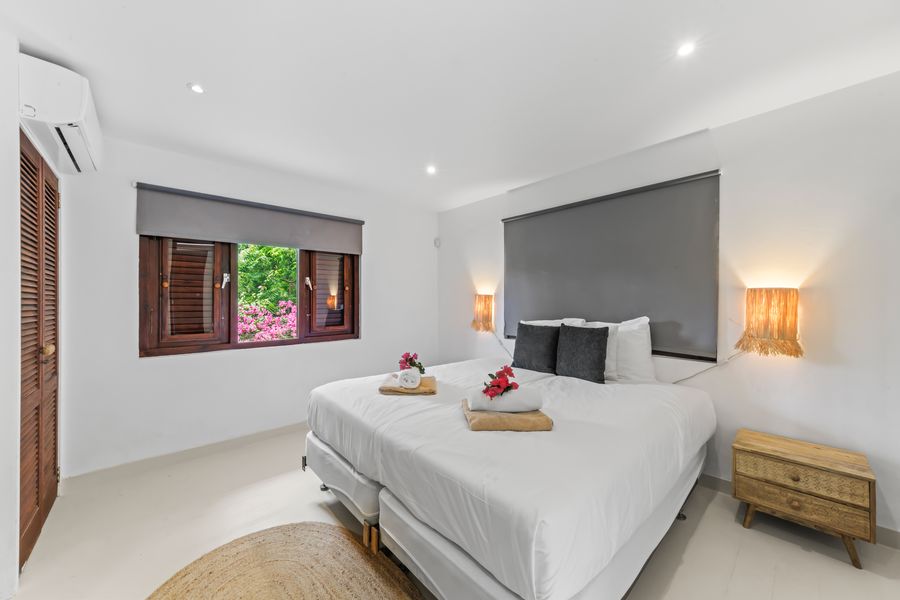 Bedroom with a desk and wooden wardrobe wall