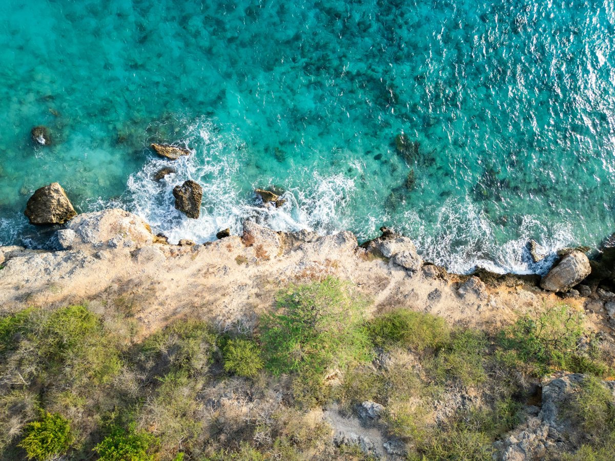 The rugged west coast from above, turquoise water on the rocks